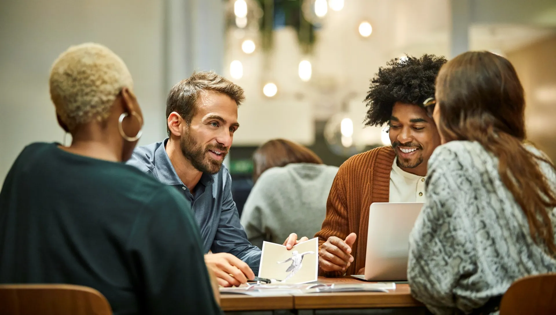 a group of people sitting around a table a group of people sitting around a table