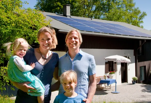 a family posing for a photo in front of a house
