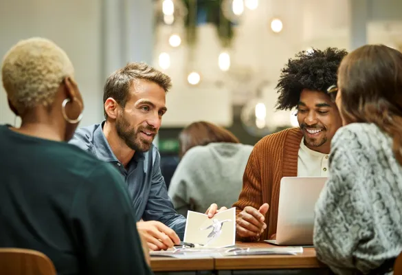 a group of people sitting around a table