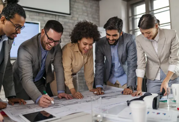 a group of people looking at a blueprint