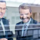 Eine Gruppe von Männern, die auf eine Glaswand schauen