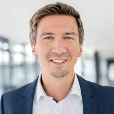 a man in a suit smiling