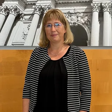a woman standing in front of a picture of a building