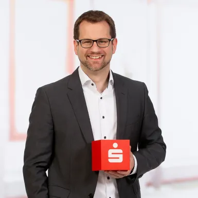 a man in a suit holding a box